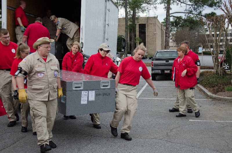Disaster medical responders unloading equipment during a training exercise.
