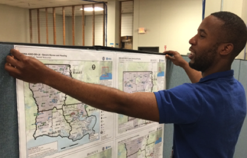 Fig. 1. FEMA Corps member Aaron Lockwood of Topaz 5, is working with GIS in producing disaster affected maps of critical infrastructure during flooding in Louisiana (Source: Paul Whitman/FEMA, April 2016).